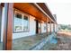Covered front porch with stained wood posts and a stained concrete floor at 1405 Coppergate Dr, Salisbury, NC 28147