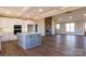 Open kitchen with island, white cabinets, and stainless steel appliances at 1405 Coppergate Dr, Salisbury, NC 28147