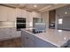 Modern kitchen with large island, quartz counters, and stainless steel appliances at 1405 Coppergate Dr, Salisbury, NC 28147
