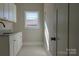 Bright laundry room, featuring white cabinets and a window at 1405 Coppergate Dr, Salisbury, NC 28147