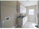 Bright laundry room with sink, granite countertop, window and cabinet storage at 1405 Coppergate Dr, Salisbury, NC 28147