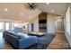 Bright living room features a stone fireplace, vaulted ceilings, hardwood floors, and open floor plan connecting to the kitchen at 1405 Coppergate Dr, Salisbury, NC 28147