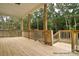 A spacious back porch, constructed with natural wood, provides the perfect outdoor living space surrounded by trees at 106 Windbluff Ct # 163, Statesville, NC 28677