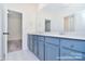 Stylish bathroom featuring blue vanity, quartz countertop, and decorative floor tiles at 106 Windbluff Ct # 163, Statesville, NC 28677