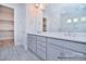 Bright bathroom featuring gray vanity, walk-in closet, and shower at 106 Windbluff Ct # 163, Statesville, NC 28677