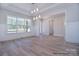 Sunlit dining area featuring large windows, elegant trim, and modern light fixture, perfect for entertaining guests at 106 Windbluff Ct # 163, Statesville, NC 28677