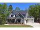 Two-story home featuring stone accents, a covered front porch, and an attached two-car garage at 106 Windbluff Ct # 163, Statesville, NC 28677