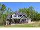 Two-story home featuring stone accents, a covered front porch, and an attached two-car garage at 106 Windbluff Ct # 163, Statesville, NC 28677