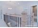 Upstairs hallway featuring a chandelier and wood/metal railing at 106 Windbluff Ct # 163, Statesville, NC 28677