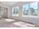 Bright living area showcasing large windows that flood the space with natural light, highlighting the sleek wood flooring at 106 Windbluff Ct # 163, Statesville, NC 28677