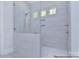Modern shower with glass enclosure, gray tile, and built-in shelving at 106 Windbluff Ct # 163, Statesville, NC 28677