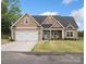 Tan house with white trim, two-car garage, and a front porch at 2165 Smith Rd # 9, Clover, SC 29710