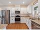 Modern kitchen with white cabinets, granite counters, and stainless steel appliances at 2165 Smith Rd # 9, Clover, SC 29710