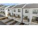 Three-story townhomes featuring black-trimmed windows and small front balconies over the garage at 4210 Alexander View Dr # 38, Charlotte, NC 28226