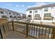 A balcony with wooden railing overlooks townhomes with garages and driveways at 4210 Alexander View Dr # 38, Charlotte, NC 28226