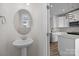 Bathroom featuring a pedestal sink and mirror with a view into the kitchen at 4210 Alexander View Dr # 38, Charlotte, NC 28226