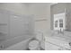 Bright bathroom features a tub with shower and white vanity with modern faucet at 4210 Alexander View Dr # 38, Charlotte, NC 28226