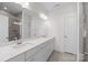 Modern bathroom with double sinks, a large mirror, and a tiled shower at 4210 Alexander View Dr # 38, Charlotte, NC 28226