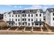 Three-story townhomes featuring black-trimmed windows, covered front porches and landscaped front yards at 4210 Alexander View Dr # 38, Charlotte, NC 28226