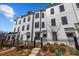 Charming, modern townhomes featuring black-trimmed windows and landscaped front yards with black metal fences at 4210 Alexander View Dr # 38, Charlotte, NC 28226