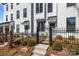 Modern townhome exteriors with black trimmed windows, garden beds, and black metal fences at 4210 Alexander View Dr # 38, Charlotte, NC 28226