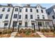 New construction townhomes with a black metal fence and landscaped front yard at 4214 Alexander View Dr # 39, Charlotte, NC 28226