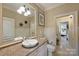 Comfortable bathroom with granite counters, a framed mirror and a door leading to bedroom at 525 Lake Lynn Rd, Concord, NC 28025