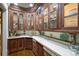 Butler's pantry with glass-front cabinets, custom woodwork, and a classic countertop sink at 525 Lake Lynn Rd, Concord, NC 28025