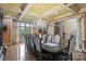 Elegant dining room featuring coffered ceilings, a crystal chandelier, and a large window with a picturesque view at 525 Lake Lynn Rd, Concord, NC 28025