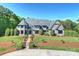 Handsome stone house with lush landscaping and manicured lawn, offering curb appeal at 525 Lake Lynn Rd, Concord, NC 28025