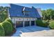 Three-car garage with stone facade and ample driveway space at 525 Lake Lynn Rd, Concord, NC 28025