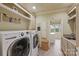 Well-equipped laundry room with modern washer and dryer units, ample storage, and utility sink at 525 Lake Lynn Rd, Concord, NC 28025