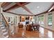 Cozy living room featuring beamed ceilings, built-in shelving, a fireplace, hardwood floors, and French doors to the pool at 525 Lake Lynn Rd, Concord, NC 28025