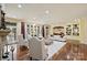 Sunlit living room with fireplace, hardwood flooring, large windows, and luxurious white sofas at 525 Lake Lynn Rd, Concord, NC 28025