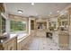 Luxurious bathroom featuring a jacuzzi tub with a large window and abundant vanity space at 525 Lake Lynn Rd, Concord, NC 28025