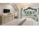 Bright main bedroom with elegant chandelier, large window seat, and a mirrored dressing area at 525 Lake Lynn Rd, Concord, NC 28025