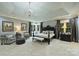 Airy main bedroom featuring a tray ceiling, a decorative chandelier, and expansive windows at 525 Lake Lynn Rd, Concord, NC 28025