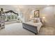 Bright main bedroom with elegant chandelier and large window seat with backyard views at 525 Lake Lynn Rd, Concord, NC 28025