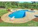 Aerial view of a backyard featuring an in-ground pool with slide, diving board, spa and surrounding patio at 525 Lake Lynn Rd, Concord, NC 28025