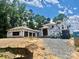 New construction home featuring a unique roof design and high-quality Tyvek weather-resistant barrier at 8022 Litaker Manor Ct, Charlotte, NC 28270