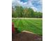 Lush green lawn and trees, with a view of a golf course in the distance at 218 Fairway Dr, Shelby, NC 28150