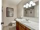 Bathroom featuring a vanity, tiled countertop, and a decorative mirror above the toilet at 218 Fairway Dr, Shelby, NC 28150