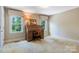 A bedroom with a desk and chair features two large windows with tree views at 218 Fairway Dr, Shelby, NC 28150