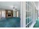 Cozy bonus room showcasing brick fireplace and access to the outdoor patio through glass windows at 218 Fairway Dr, Shelby, NC 28150