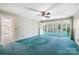 Large bonus room with neutral carpet, ceiling fan, and access to the sunroom for relaxing at 218 Fairway Dr, Shelby, NC 28150