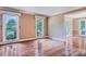 A bright living room featuring hardwood floors and large windows overlooking a lawn at 218 Fairway Dr, Shelby, NC 28150