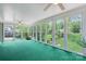 Bright sunroom with multiple windows offering expansive views of the landscaped backyard at 218 Fairway Dr, Shelby, NC 28150