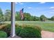 A gorgeous golf course view from a porch with American flag in the background at 218 Fairway Dr, Shelby, NC 28150