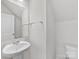 Clean bathroom with white sink and toilet, and a mirrored medicine cabinet at 2121 Acclaim St, Charlotte, NC 28205