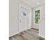 Bright entryway with white door, wood-look floors, and staircase at 2121 Acclaim St, Charlotte, NC 28205